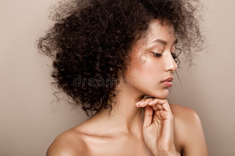 Fashion studio portrait of beautiful african american woman with perfect smooth glowing skin. Fashion studio portrait of beautiful african american woman with perfect smooth glowing skin