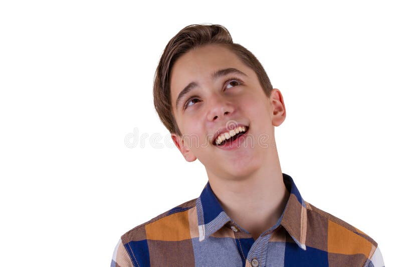 Portrait of attractive teen boy smiling and looking up being photographed in a studio. Isolated on white background. Portrait of attractive teen boy smiling and looking up being photographed in a studio. Isolated on white background