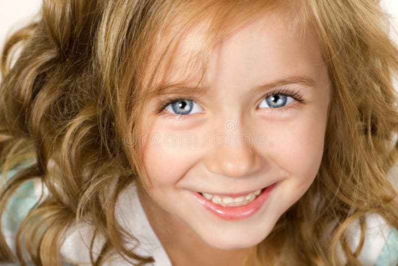 Close-up portrait smiling little girl with blue eyes, looking at camera. Close-up portrait smiling little girl with blue eyes, looking at camera