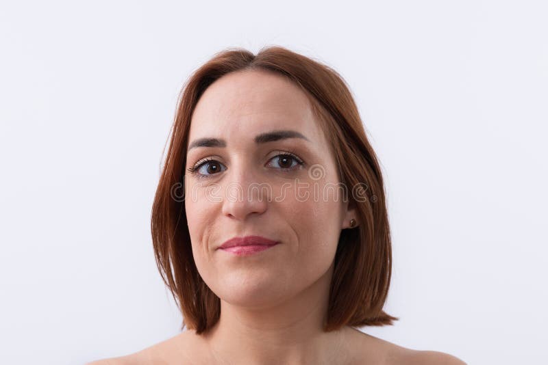 Close-up portrait of 30 years old beautiful woman, smiling and calm with short red hair looking at camera isolated on white background. Natural beauty concept. Close-up portrait of 30 years old beautiful woman, smiling and calm with short red hair looking at camera isolated on white background. Natural beauty concept