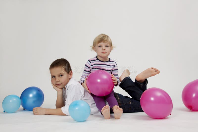 Brother and sister studio portrait with balloons. Brother and sister studio portrait with balloons