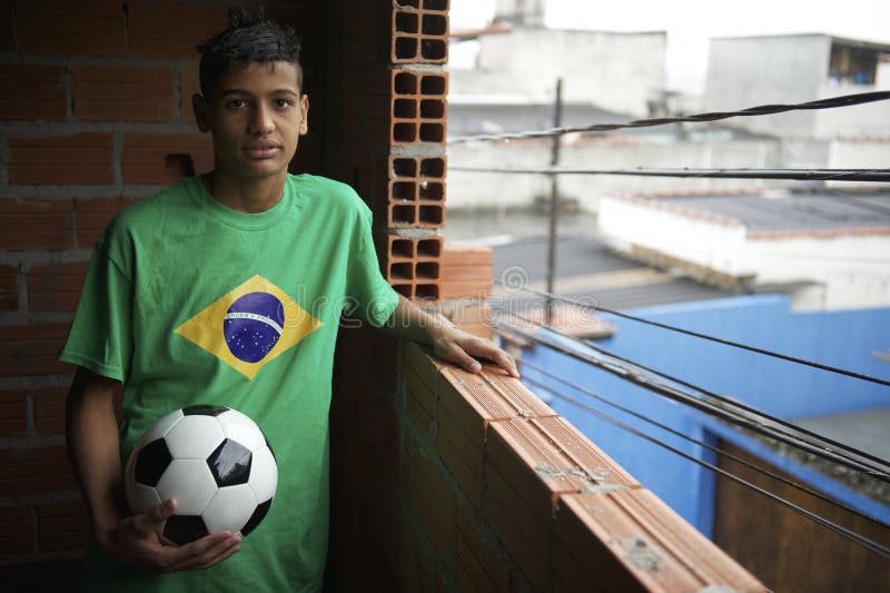Retrato do jogador de futebol brasileiro novo que está com futebol imagem de stock Retrato do jogador de futebol brasileiro novo que está com futebol imagem de stock