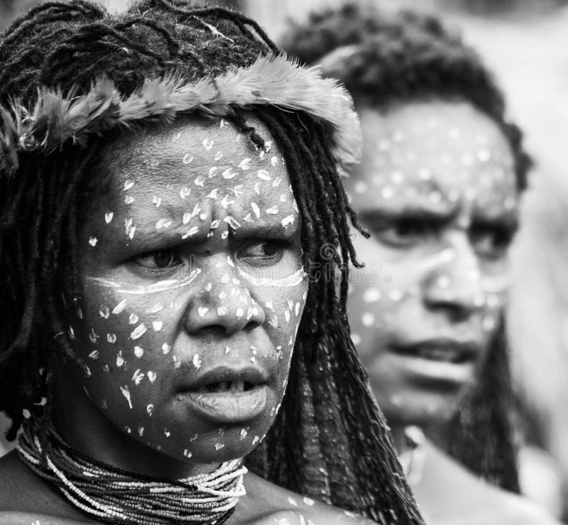 DANI VILLAGE, WAMENA, IRIAN JAYA, NEW GUINEA, INDONESIA â€“ 15 MAY 2012: Portrait of Woman Dani tribe in ritual coloring on the body and face. DANI VILLAGE, WAMENA, IRIAN JAYA, NEW GUINEA, INDONESIA â€“ 15 MAY 2012: Portrait of Woman Dani tribe in ritual coloring on the body and face.