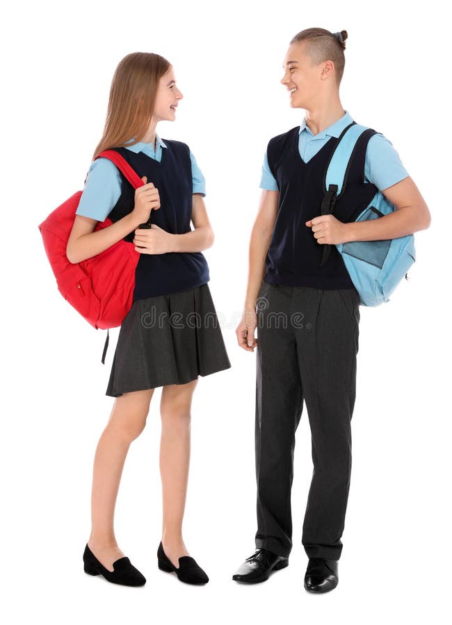 Retrato integral de adolescentes en uniforme escolar con las mochilas foto de archivo Retrato integral de adolescentes en uniforme escolar con las mochilas foto de archivo