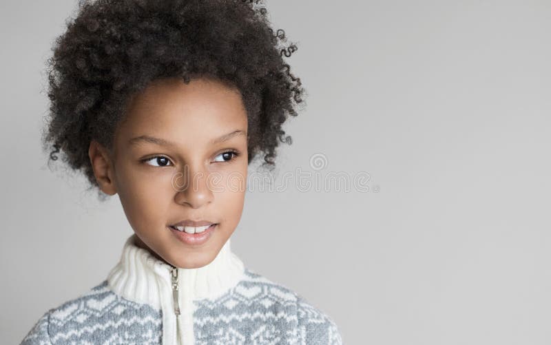 Retrato lindo de niña. tiro de estudio de suéter de invierno con niño gracioso. aislado en fondo gris imagen de archivo