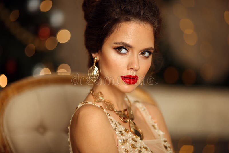 Retrato Luxuoso De Uma Mulher Elegante Com Penteado De Casamento E Maquiagem.  Linda Morena Com Joias Douradas Em Vestido De Baile Foto de Stock - Imagem  de forma, fundo: 203797122