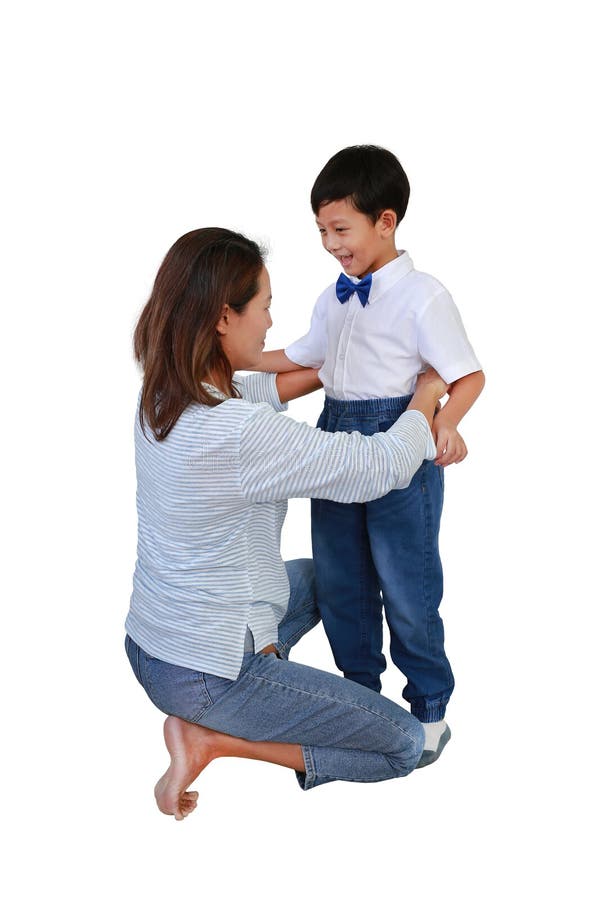 Retrato Mamá asiática ayudando a su hijo a vestirse aislada en el fondo de un estudio blanco. Longitud completa de la imagen imágenes de archivo libres de regalías