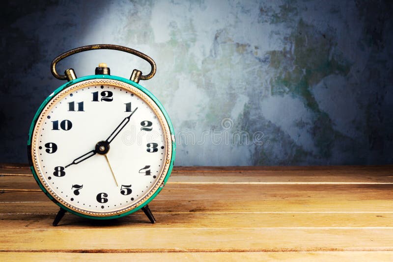 Retro alarm clock on wooden table