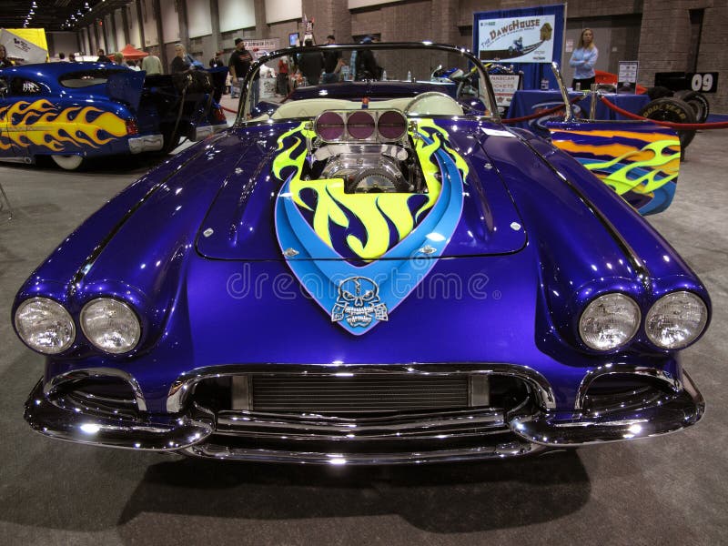 Photo of Corvette muscle car with supercharger and fancy paint job at the Washington D.C. auto show on 2/6/09. This car was one of the early Corvettes. Photo of Corvette muscle car with supercharger and fancy paint job at the Washington D.C. auto show on 2/6/09. This car was one of the early Corvettes.