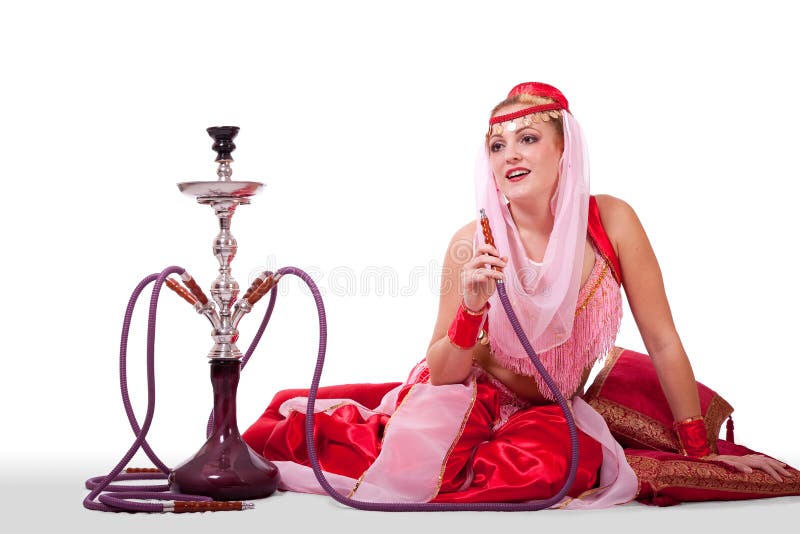 A woman in a retro belly dance costume poses with a hookah, looking entertained in conversation. A woman in a retro belly dance costume poses with a hookah, looking entertained in conversation.