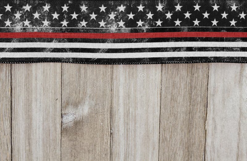 Retro USA patriotic old thin red line flag on a weathered wood background with copy space. Retro USA patriotic old thin red line flag on a weathered wood background with copy space