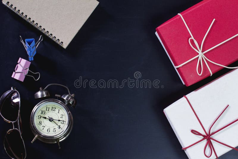 Retro Clock with Gift Box and Office Supplies on Blackboard. Stock