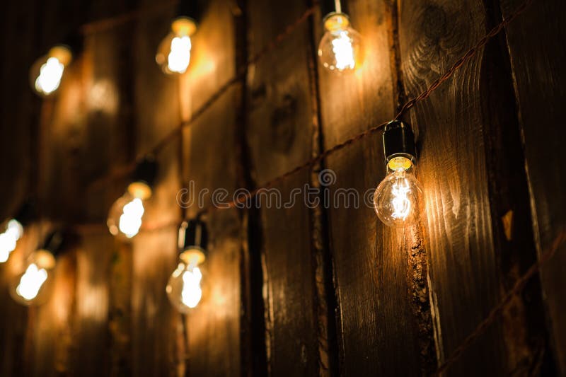 Retro Lamp with Plug and Cable Hanging on the Wooden Wall Stock Photo