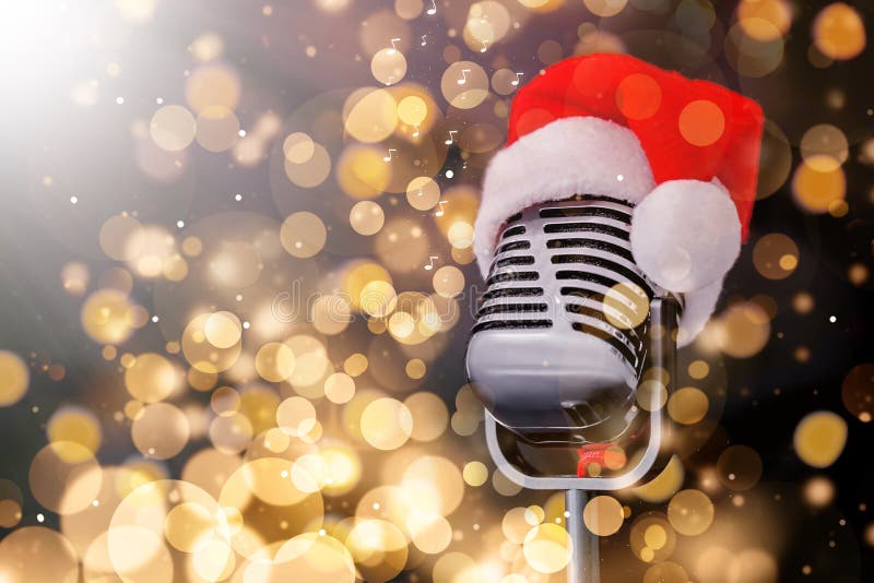 Retro microphone with Santa hat against blurred lights, space for text. Christmas music. Bokeh effect