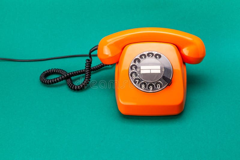 Retro phone orange color, vintage handset receiver on green background. Retro phone orange color, vintage handset receiver on green background stock photos Retro phone orange color, vintage handset receiver on green background. Retro phone orange color, vintage handset receiver on green background stock photos