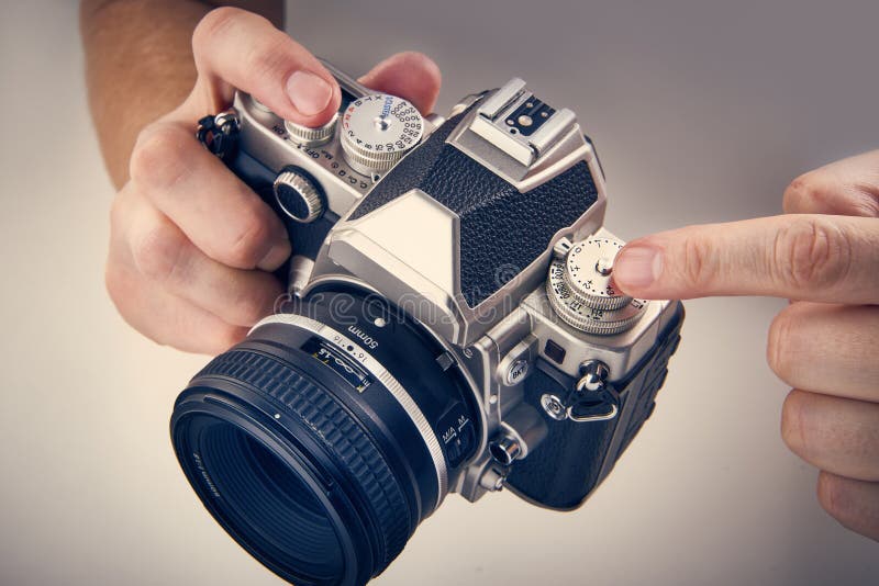 Retro SLR camera in hands of photographer closeup