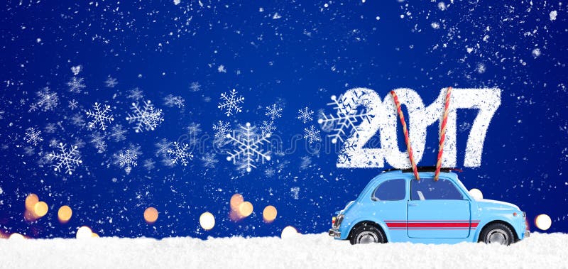 Blue retro toy car delivering Christmas or New Year 2017 on festive blue background. Blue retro toy car delivering Christmas or New Year 2017 on festive blue background