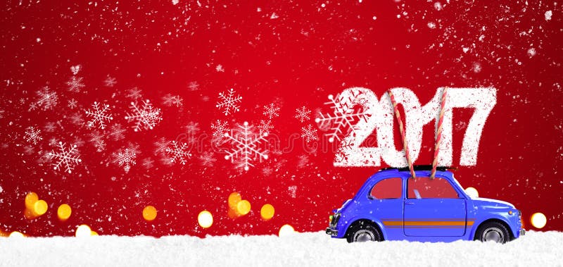 Blue retro toy car delivering Christmas or New Year 2017 on festive red background. Blue retro toy car delivering Christmas or New Year 2017 on festive red background