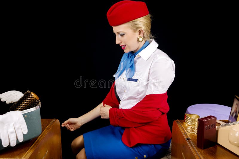 Retro Airline Stewardess or Flight Attendant Removing Her Jacket. Retro Airline Stewardess or Flight Attendant Removing Her Jacket.