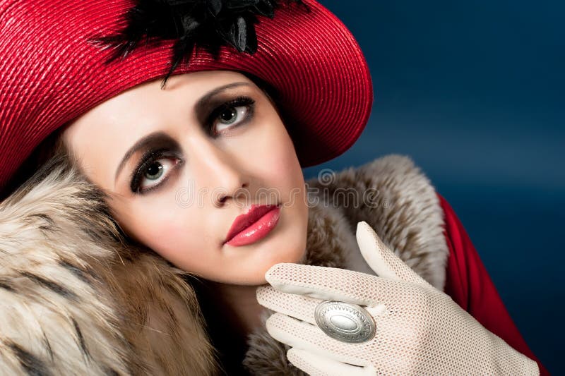 Retro style portrait of a young woman in red hat