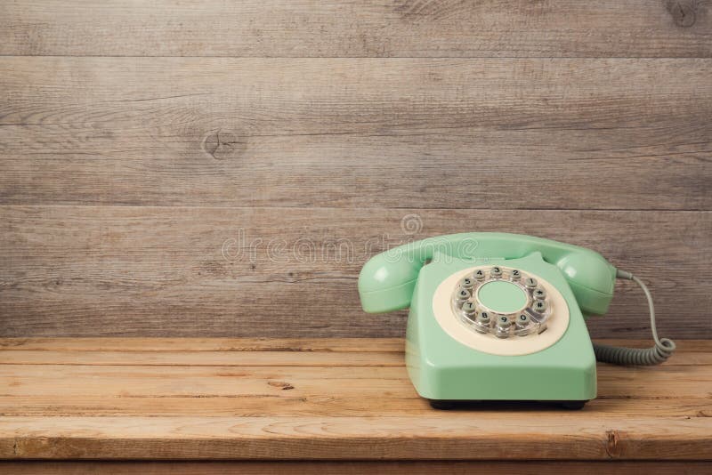 Retro telephone on wooden table. Call center or support service concept royalty free stock photography