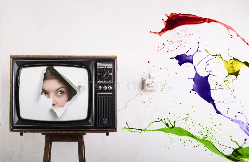 Retro TV face of a woman on the screen and bursts of color ink. Retro TV face of a woman on the screen and bursts of color ink.