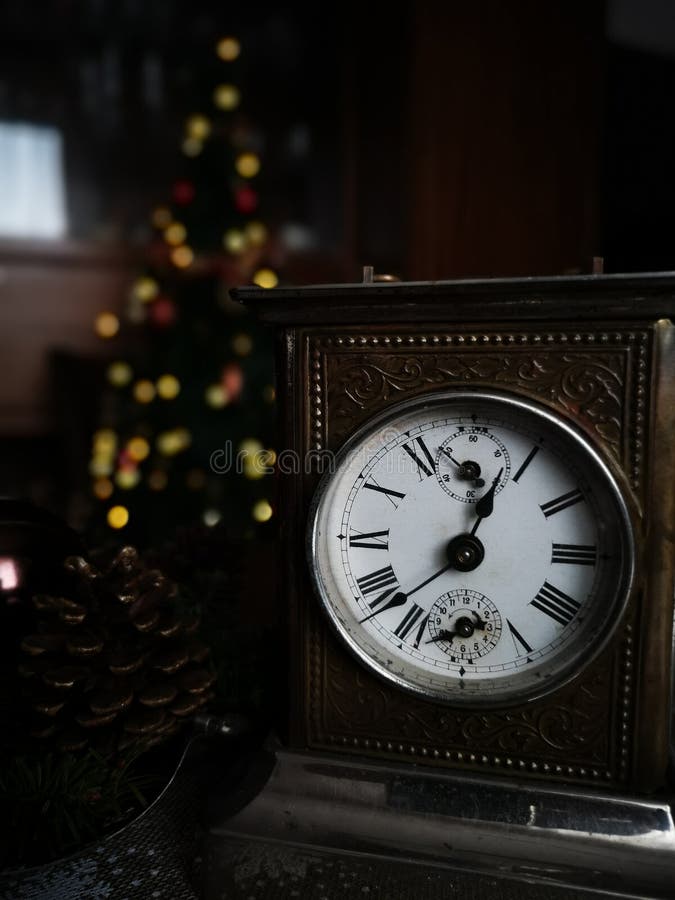 Retro vintage clock on sack closeup at 1 o`clock  with Christmas background. Retro vintage clock on sack closeup at 1 o`clock  with Christmas background.