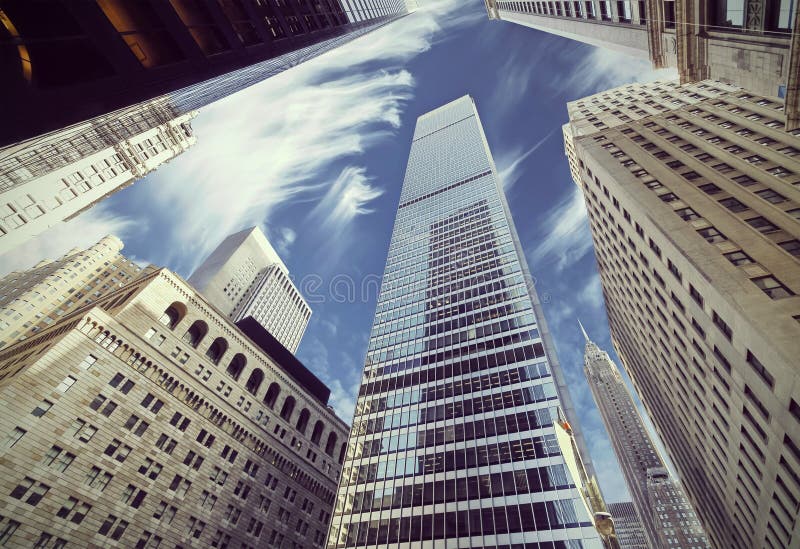 Retro filtered view of skyscrapers in Lower Manhattan, looking up at sky, New York City. Retro filtered view of skyscrapers in Lower Manhattan, looking up at sky, New York City.