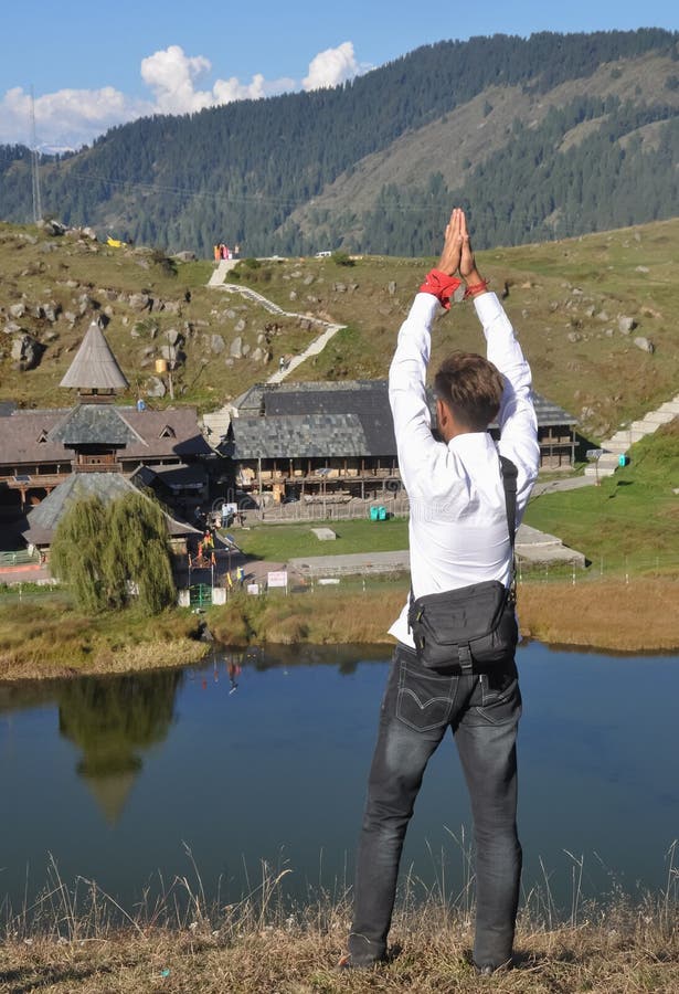 Retrovista de un turista masculino haciendo gesto de desprestigio mientras se paraba hacia el templo parashar rishi en mandi himac foto de archivo libre de regalías