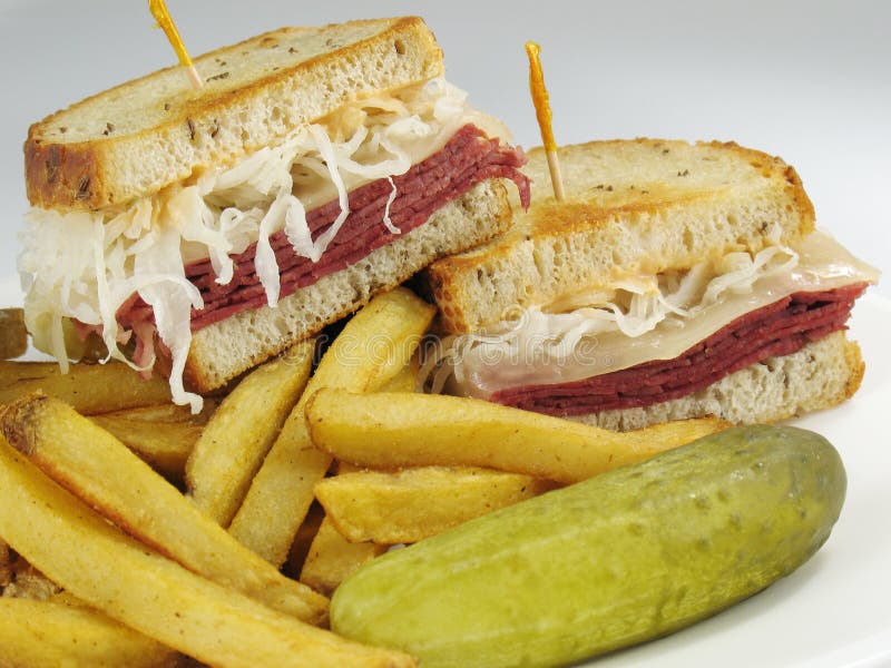 A delicious reuben sandwich: corned beef, melted swiss cheese, sauerkraut, and thousand island dressing on toasted rye bread. Served with seasoned french fries. Kosher stock images, royalty-free photos and pictures