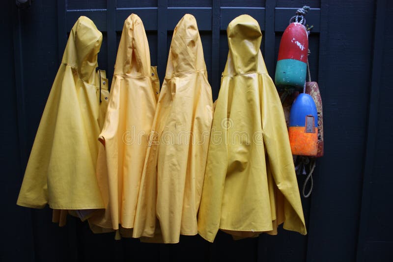 Yellow rain coats hanging on a wall. Yellow rain coats hanging on a wall