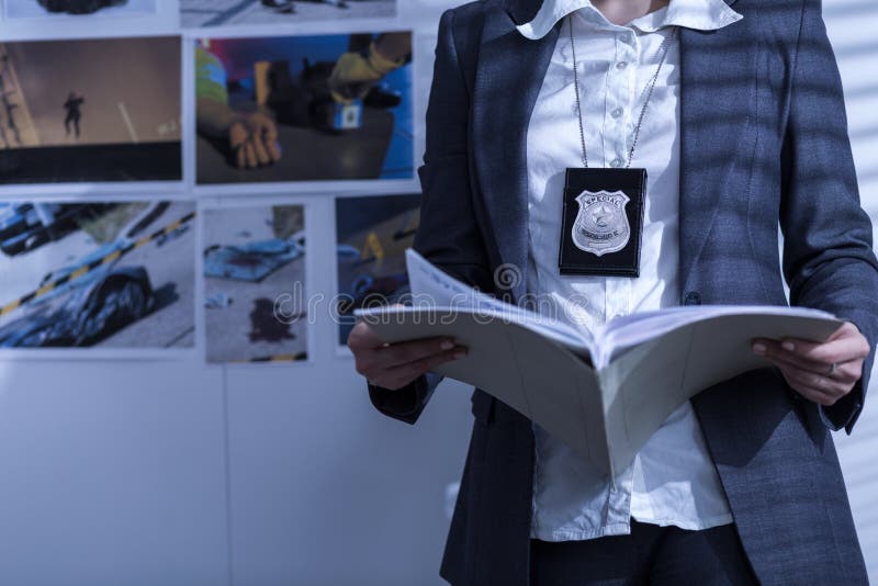 Police woman is reviewing files and documents. Detective paperwork stock images, royalty-free photos and pictures