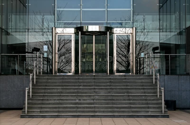 Steps leading up to revolving glass office doors