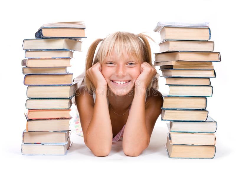 Education Concept.School Girl between the stacks of books. Education Concept.School Girl between the stacks of books.