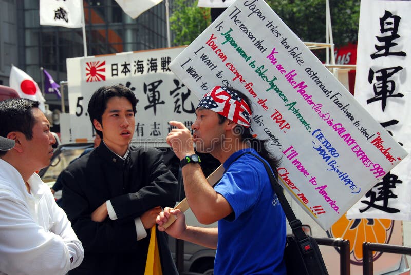 Members of a Japanese nationalist right wing group and an opponent at a public rally near Shibuya station, Tokyo. Members of a Japanese nationalist right wing group and an opponent at a public rally near Shibuya station, Tokyo