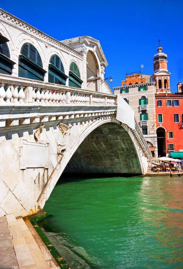 Rialto Bridge With Gondola Underneath In Venice, Italy Stock Photo