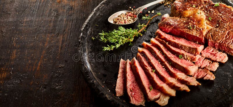 Rib eye steak served on plate