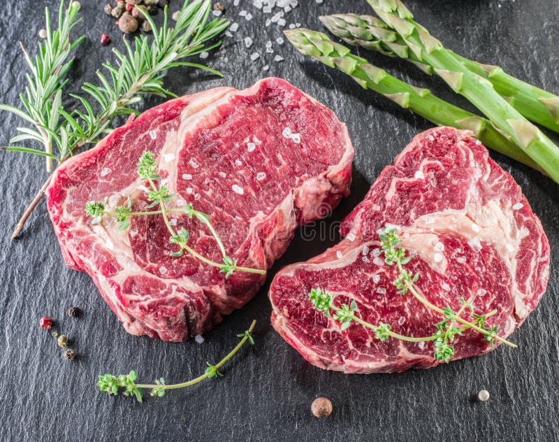 Rib Eye Steak with Spices on the Black Background. Stock Image Image