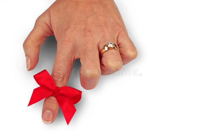 Red ribbon tied around index finger as a reminder. Red ribbon tied around index finger as a reminder