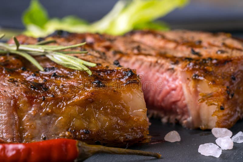 A ribeye steak with green stock photo. Image of angus 137200574