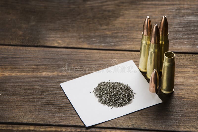 Cartridge, bullet, cartridge case and gunpowder on a wooden table. Cartridge, bullet, cartridge case and gunpowder on a wooden table