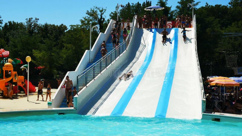 Riccione, Italy - August 2019: people having fun at water park