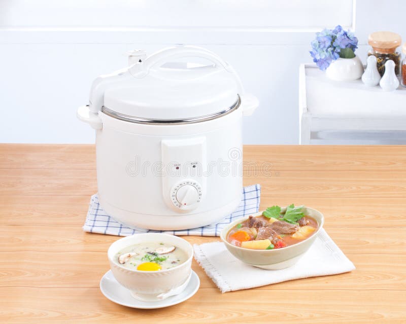 Rice cooking and electric casserole pot royalty free stock photo