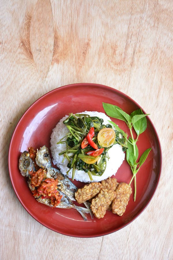 Rice, Fried Fish, Fried Tempe, Sauteed Kangkung and Sambel Goreng Stock