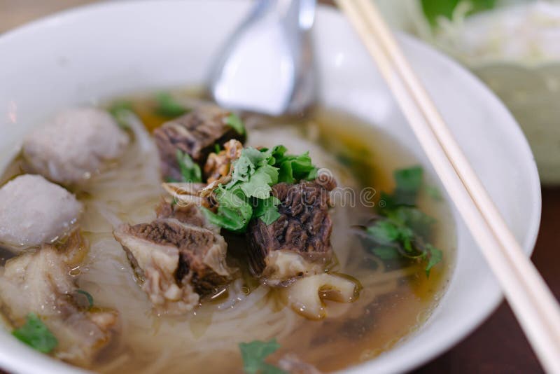 Rice Noodle Soup with Cooked Liver in Bowl on Table, Selective Focus