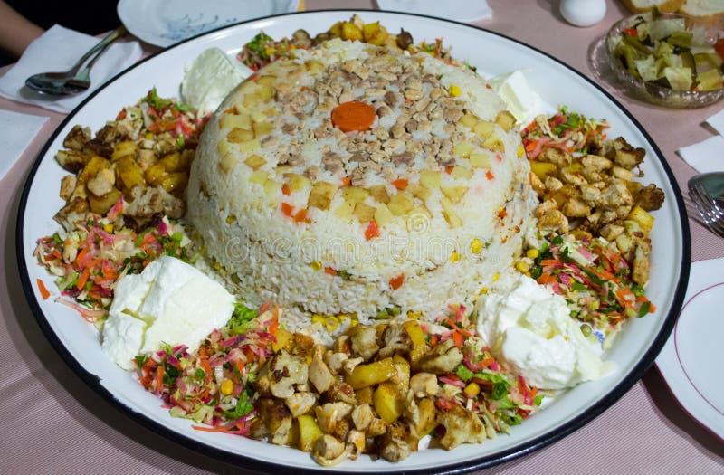 Rice Risotto with chicken meat, potato, green pea, carrot, sliced tomato and yoghurt on tray