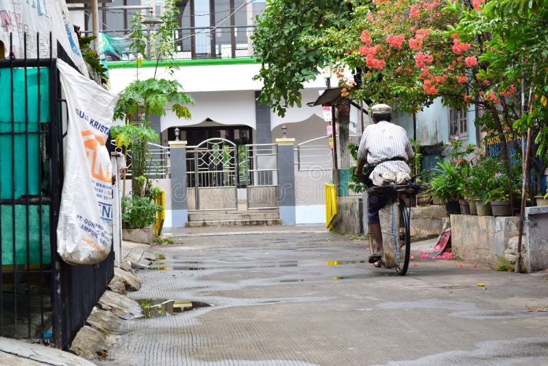 Rice sellers ride a bicycle after heavy rain royalty free stock photos Rice sellers ride a bicycle after heavy rain royalty free stock photos