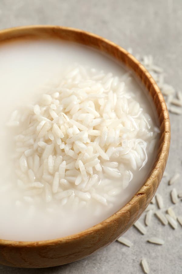 Rice Soaked in Water on Light Grey Table, Closeup Stock Photo Image