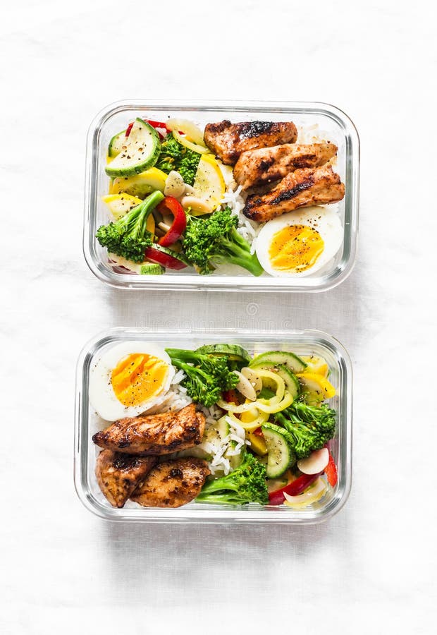 Meal prep containers with rice with chicken, baked vegetables, eggs,  sausages and salad for breakfast and lunch overhead shot, copy space, wtite  woode Stock Photo - Alamy