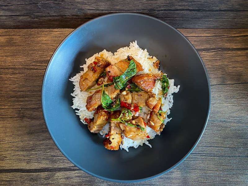 Rice Topped with Crispy Pork Belly with Thai Basil Stock Photo Image